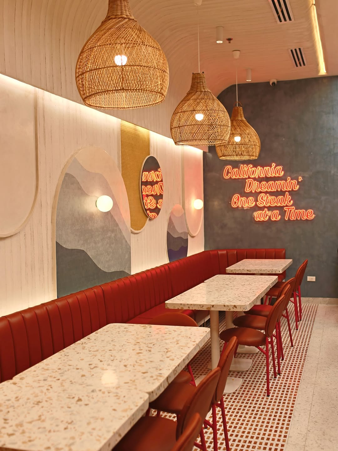 California Steaks’ real dining room with rattan lights and orange booths